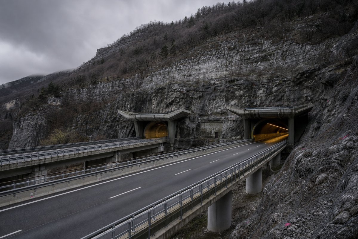 Motorway viaduct and tunnel portal in sequence along an autostrada in Italy: Apennine limestone ridge, twin concrete motorway portals with a projecting canopy. (AI-generated image)