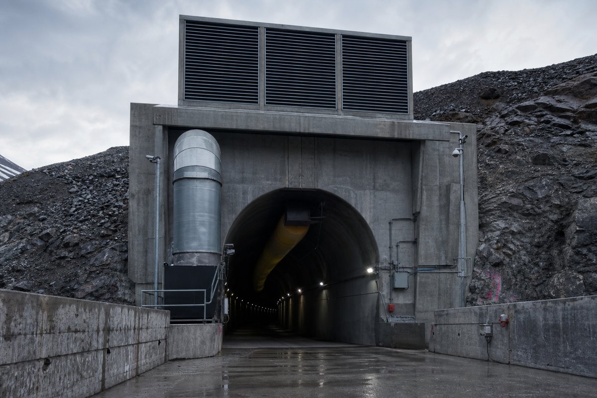 Tunnel ventilation shaft head on a hillside, ducting and louvres against open sky. (AI-generated image)